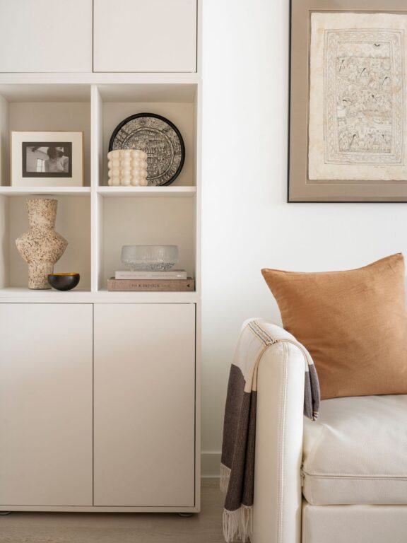 Neutral toned living room styling featuring cabinetry and a modern sofa in Toronto